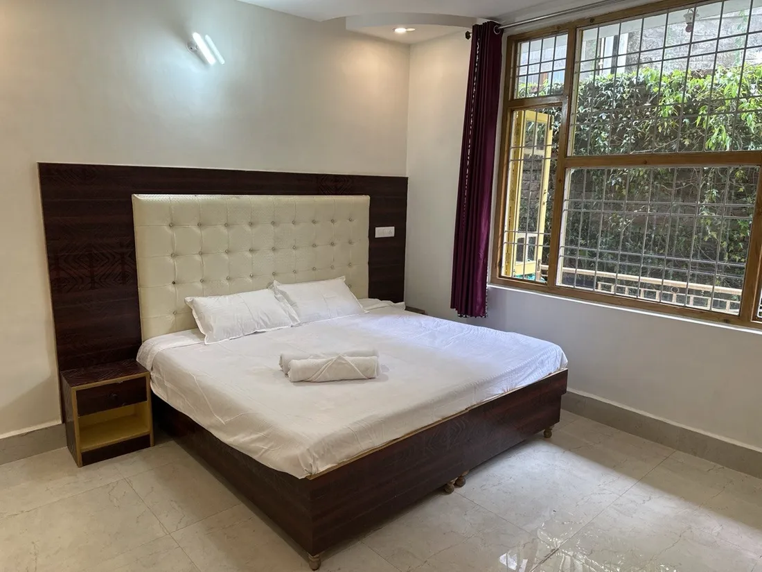 Budget room: double bed with cream tufted headboard
